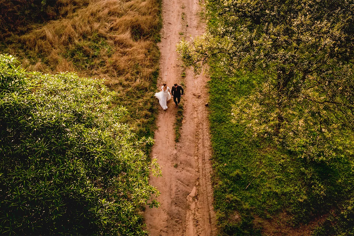 Bride and groom walking along a bush path at sunset at a wedding venue near Pietermaritzburg in KZN